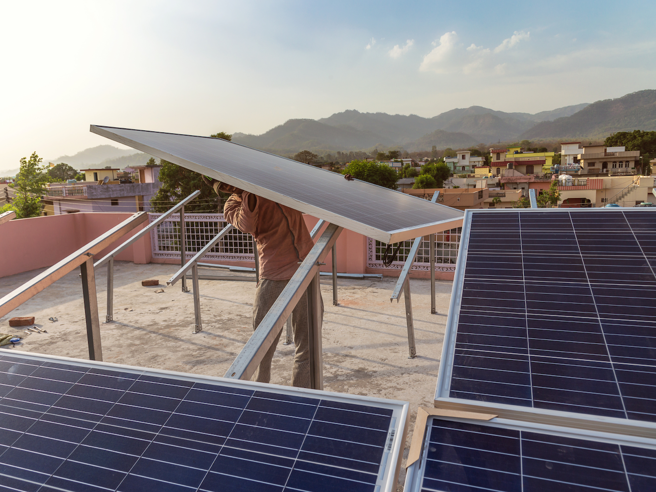 Man Lifting Solar Panel